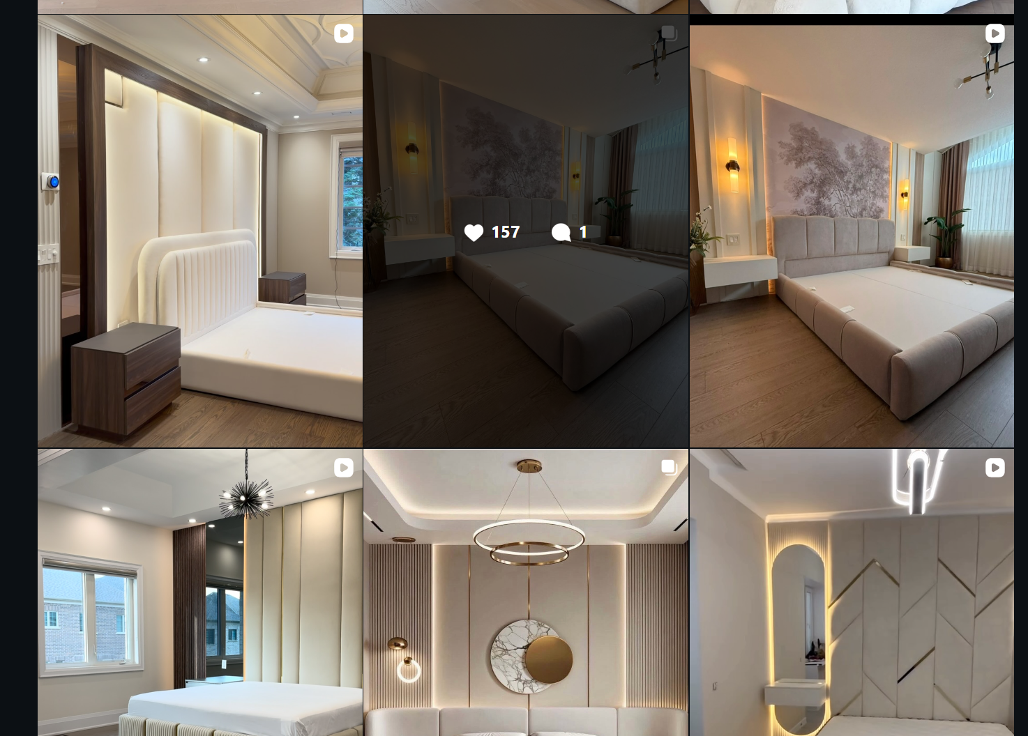 White upholstered bed surrounded by wood panels, bedside cabinetry and soft lighting